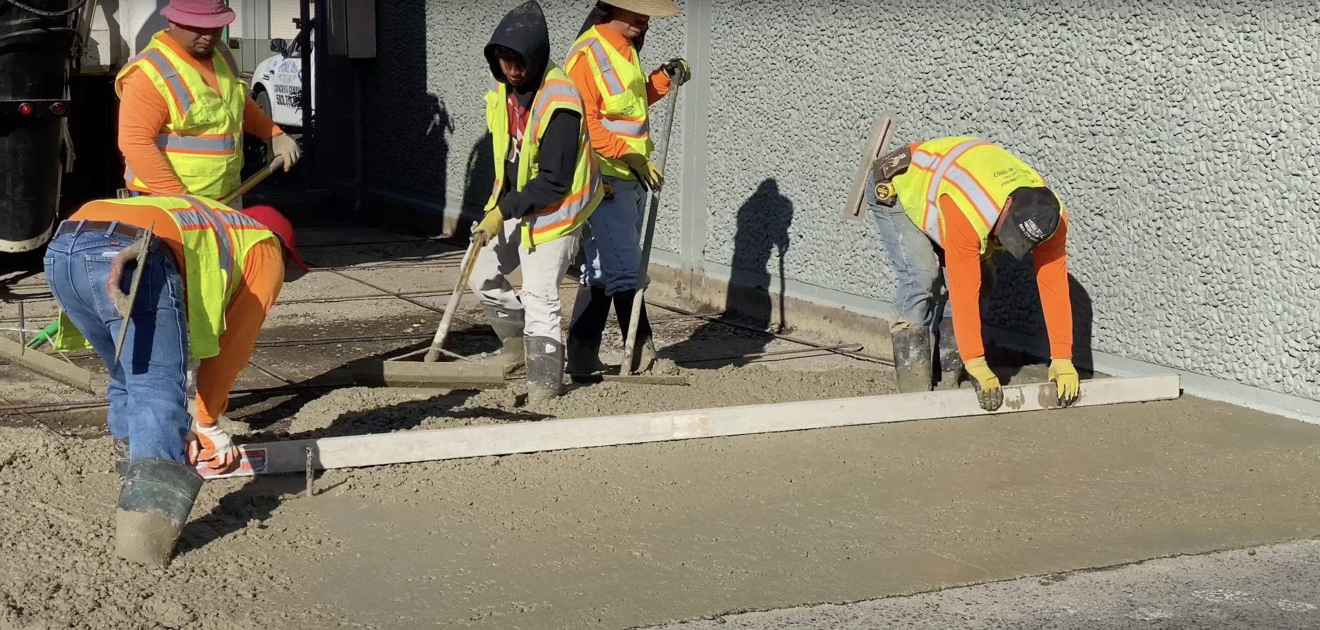 Commercial concrete crew performing precision finishing work
