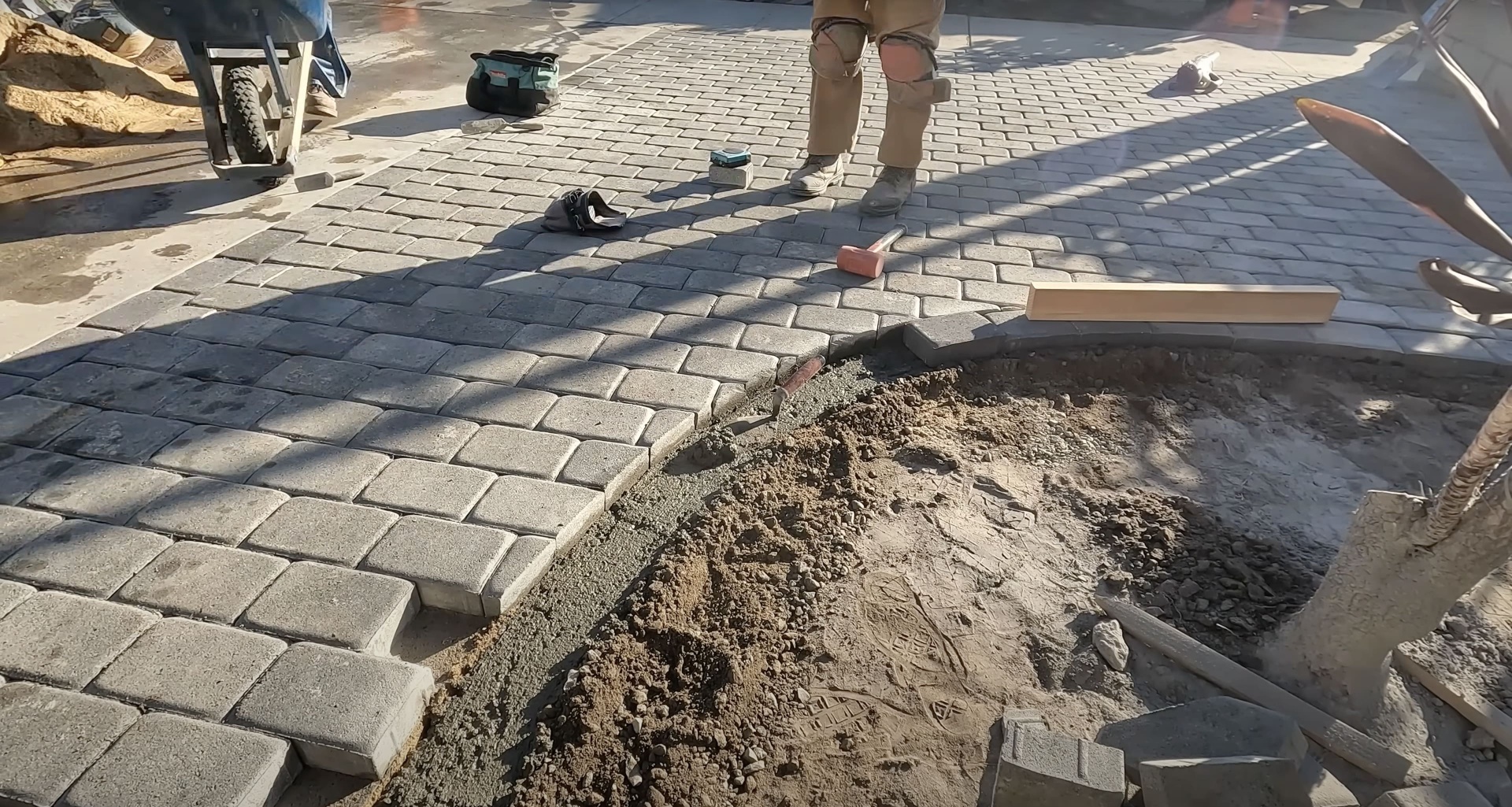 Concrete paver installation work in progress showing professional craftsmanship