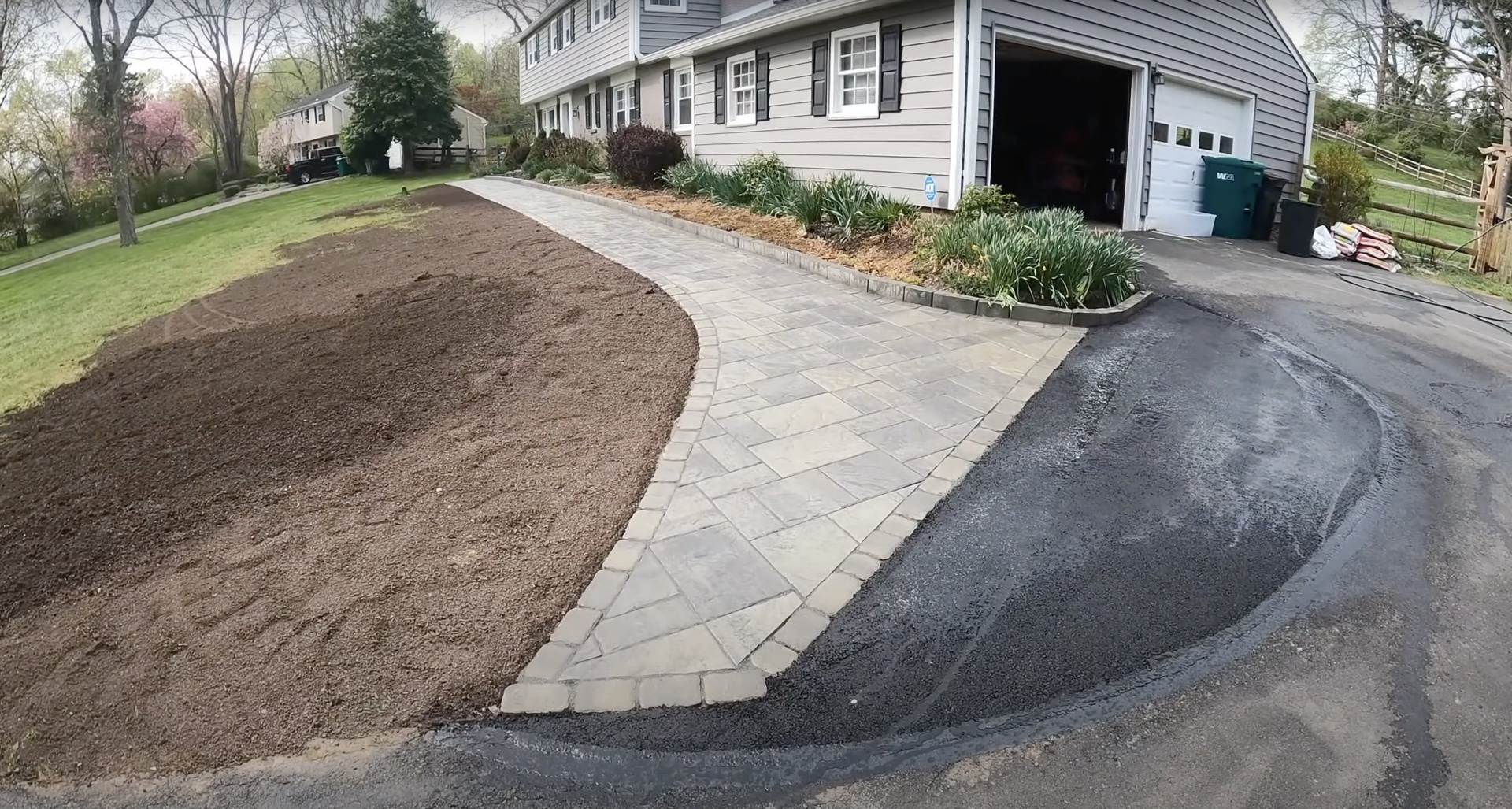 Completed paver and asphalt driveway project showing quality workmanship