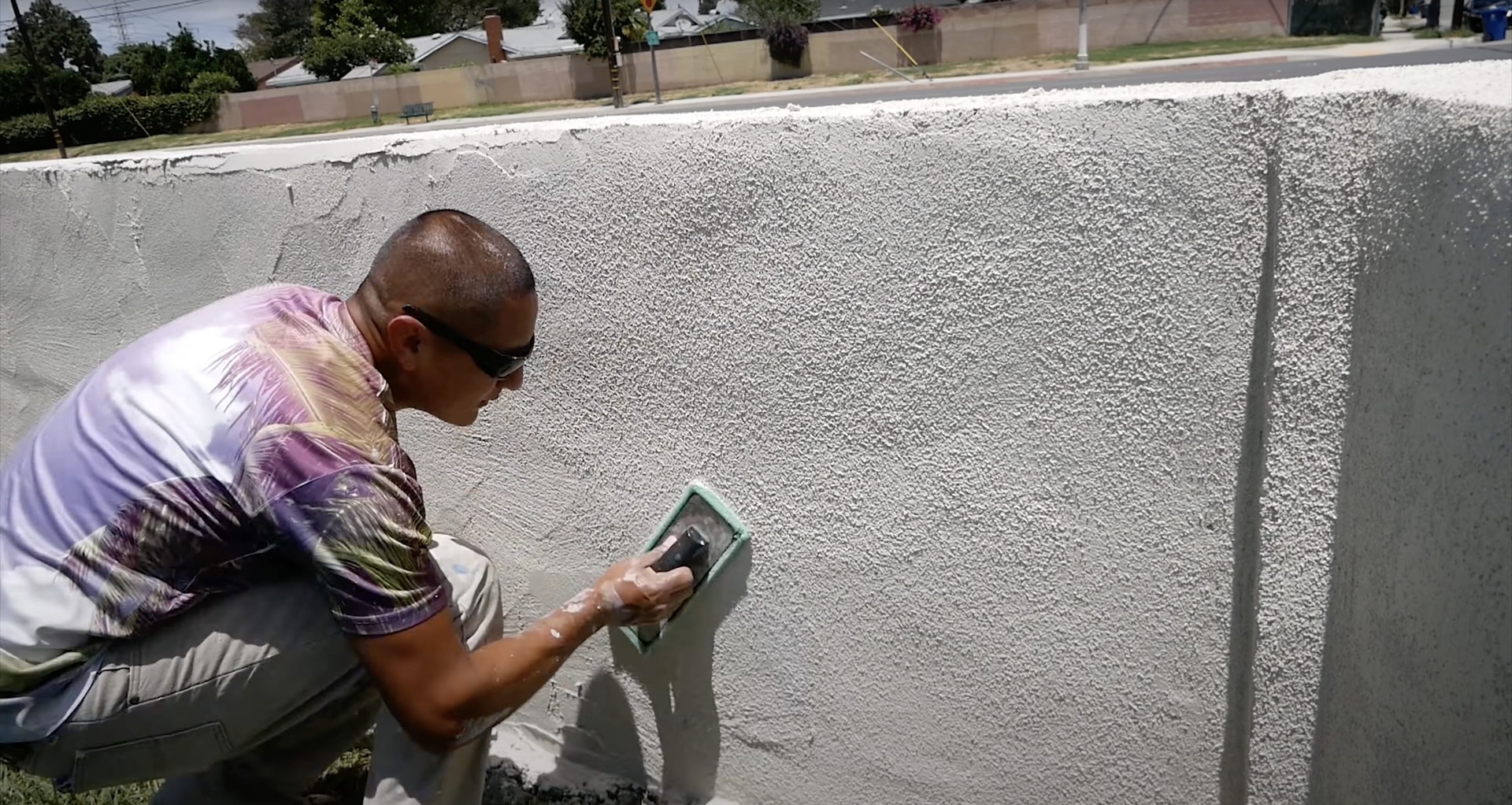 Professional concrete worker applying finishing techniques to smooth concrete surface