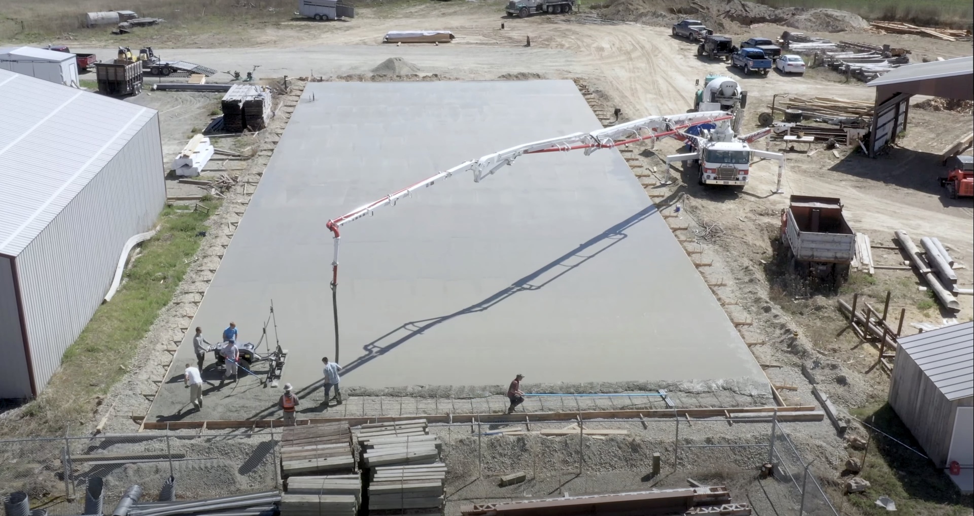 Large commercial concrete slab pour with pump truck and crew